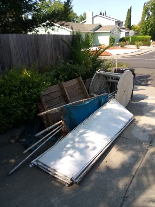 Mixed junk haul including furniture, bags, and household items