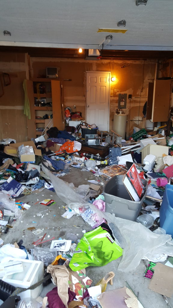 Cluttered garage before JC Junk Hauling cleanout